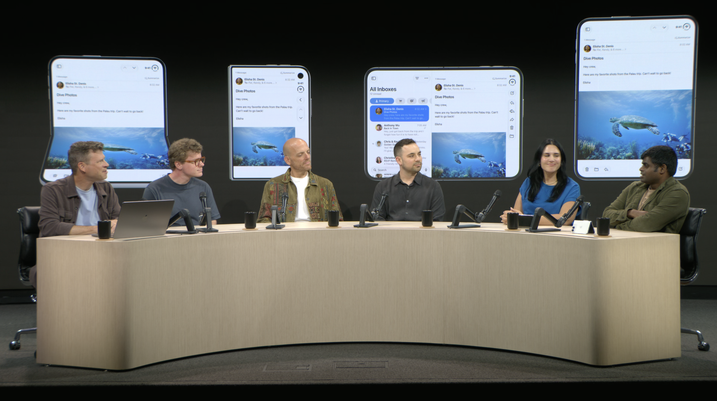 Six panelists seated at a table, with iPhone Duo layouts displayed behind them.